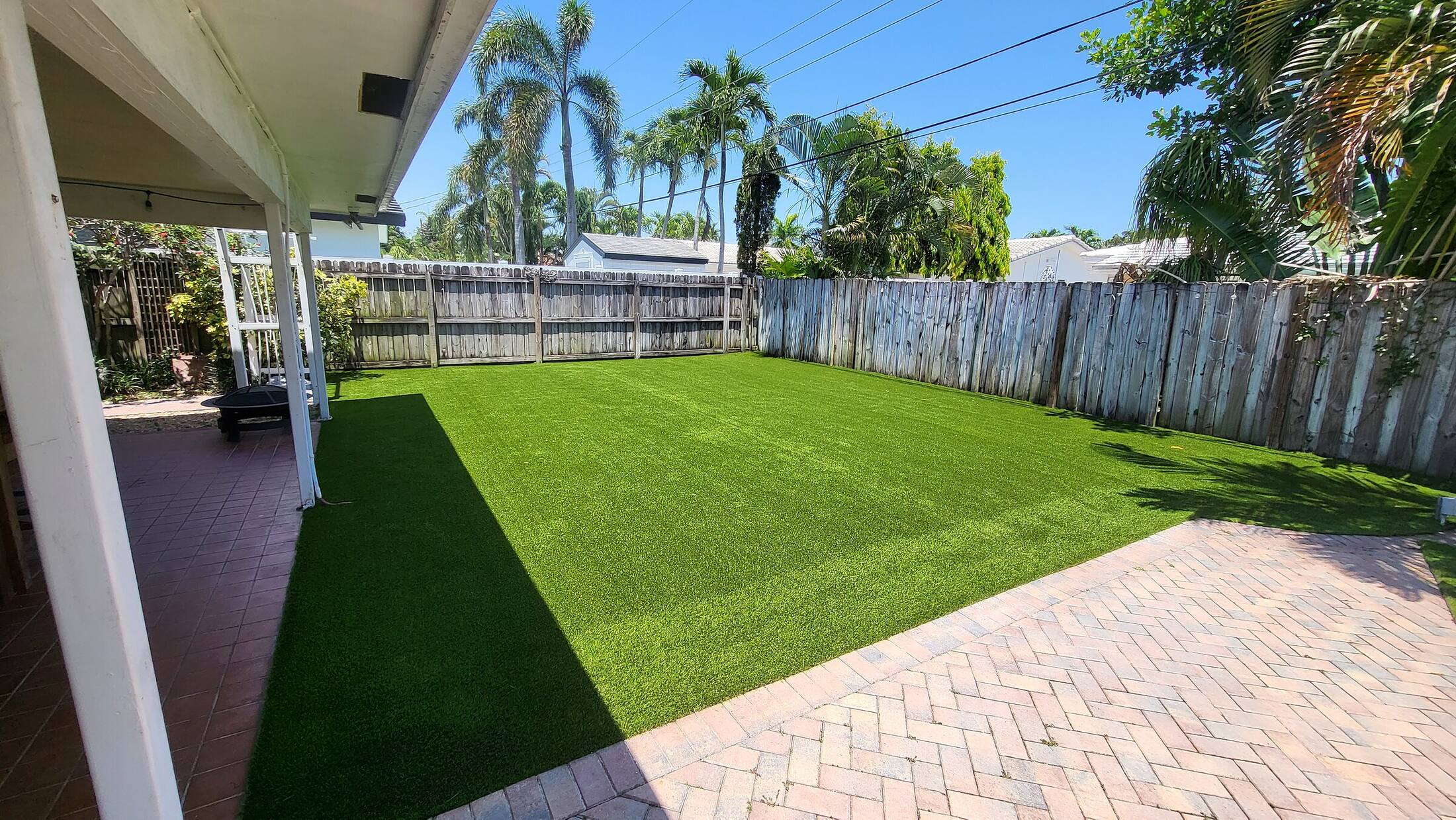 Finished artificial turf lawn with clean paver edging
